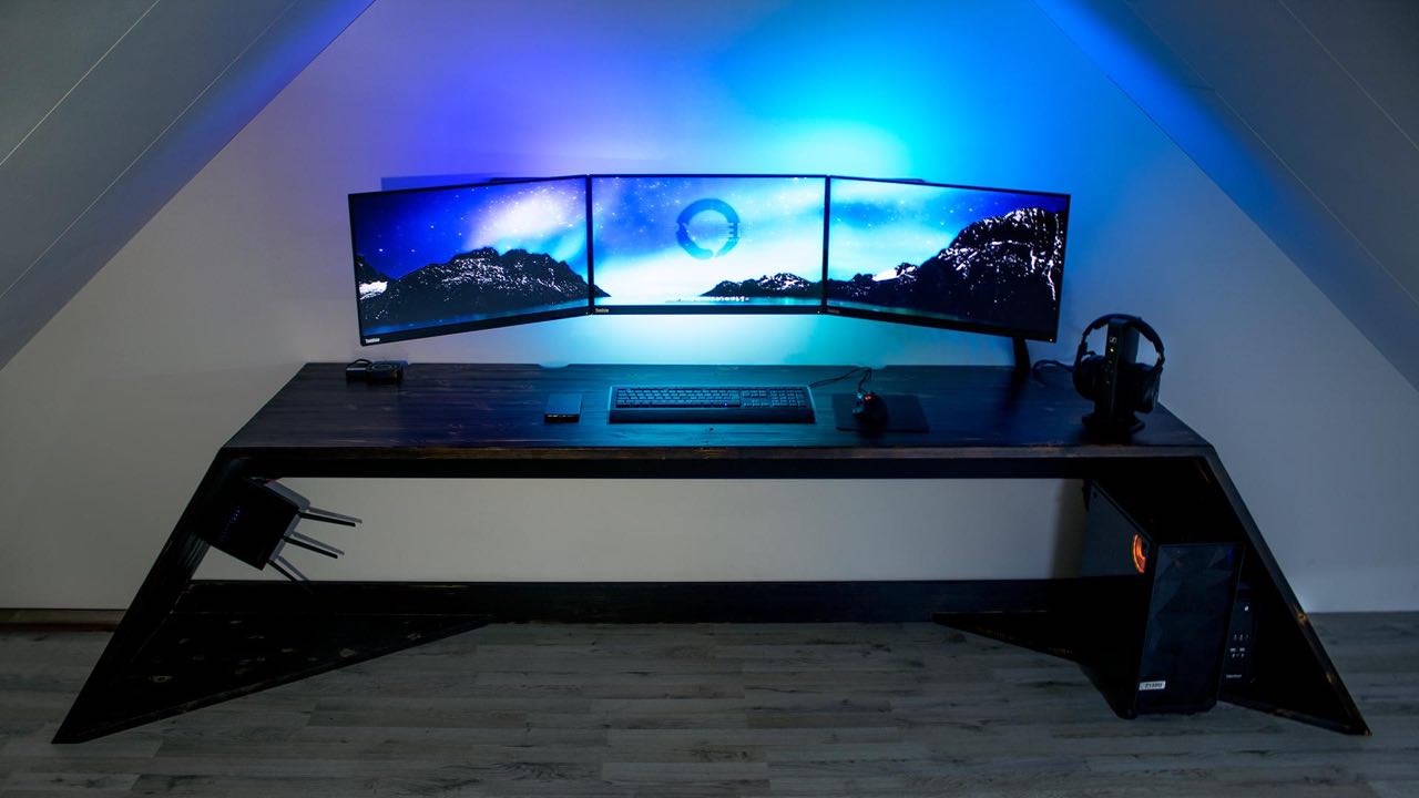 Triple monitor AV setup with blue LED accent lighting